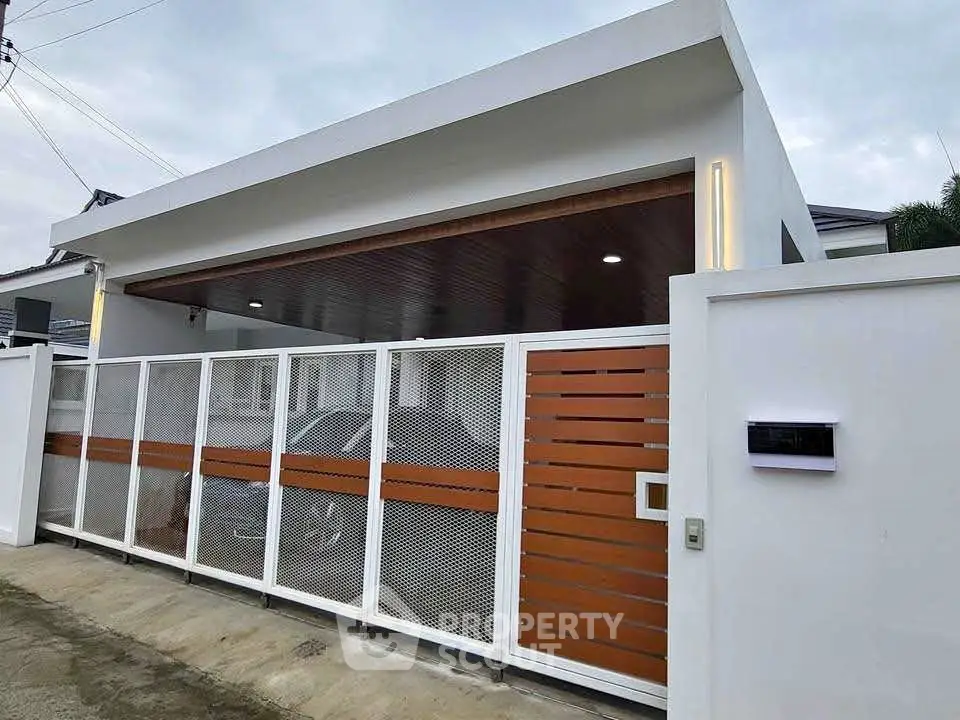 Modern minimalist house exterior with sleek gate and driveway