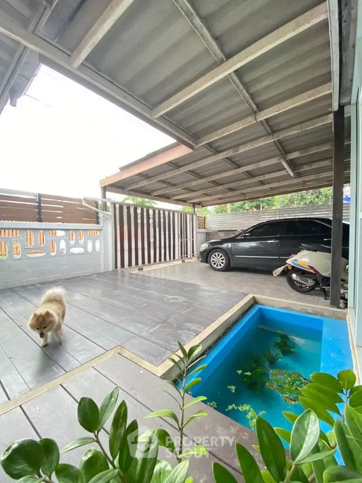 Covered parking area with small pool and greenery, perfect for urban living.