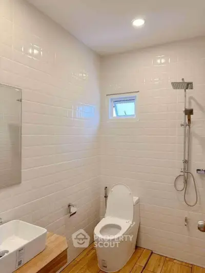 Modern bathroom with sleek fixtures and wooden flooring