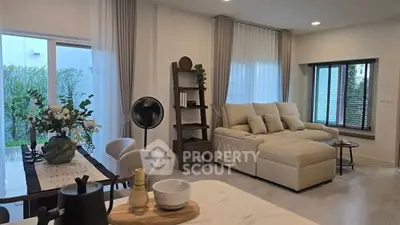 Modern living room with elegant decor and large windows overlooking garden