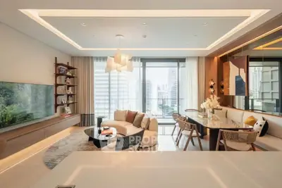 Luxurious modern living room with city view, elegant decor, and spacious layout.