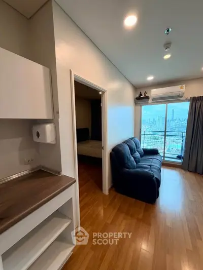 Modern apartment interior with city view, featuring cozy living room and adjacent bedroom.