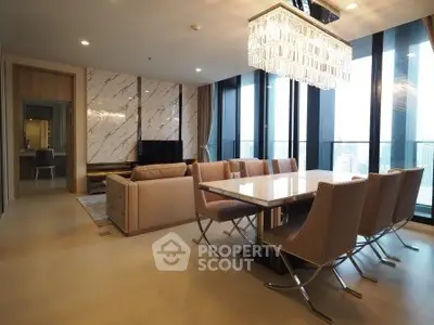 Luxurious modern living room with elegant dining area and stunning city view.