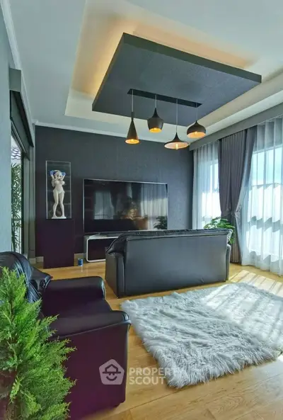 Luxurious modern living room with sleek black furniture and stylish lighting