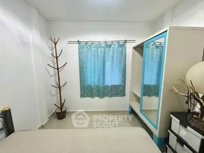 Cozy bedroom with modern wardrobe and stylish decor in a bright apartment.