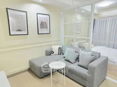 Modern living room with stylish decor and cozy gray sofa in a bright apartment.