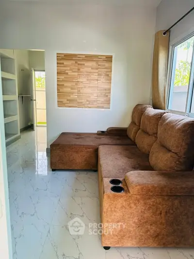 Cozy living room with plush brown sofa and modern decor