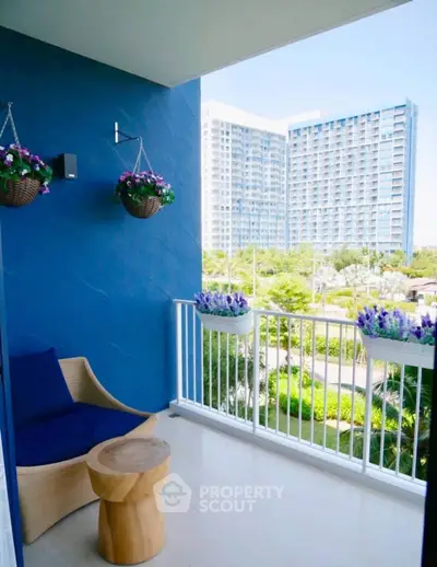 Charming balcony with modern seating and vibrant city view, perfect for relaxation and enjoying the outdoors.