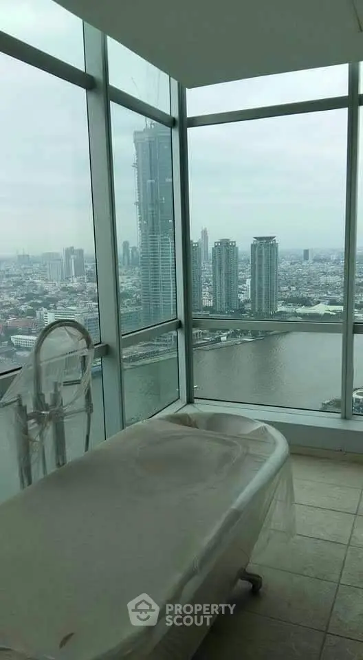 Luxurious bathtub with stunning city and river view in high-rise apartment
