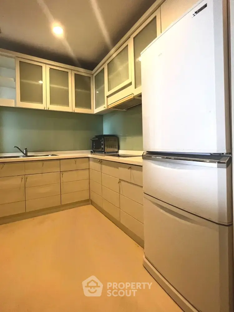Modern kitchen with sleek cabinetry and large refrigerator