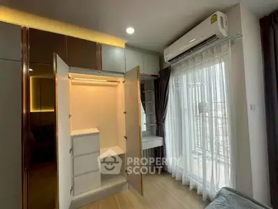 Modern bedroom with built-in wardrobe and balcony view, featuring sleek design and ample natural light.