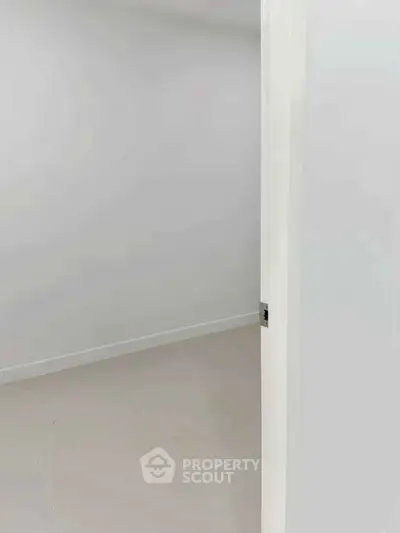 Minimalist empty room with white walls and tiled floor, perfect for customization.