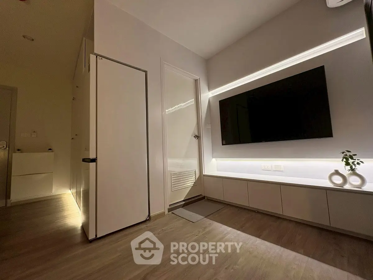 Modern living room with sleek TV setup and stylish lighting