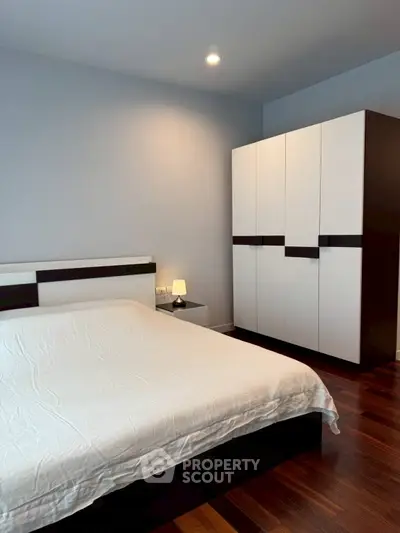 Modern bedroom with sleek wardrobe and cozy lighting