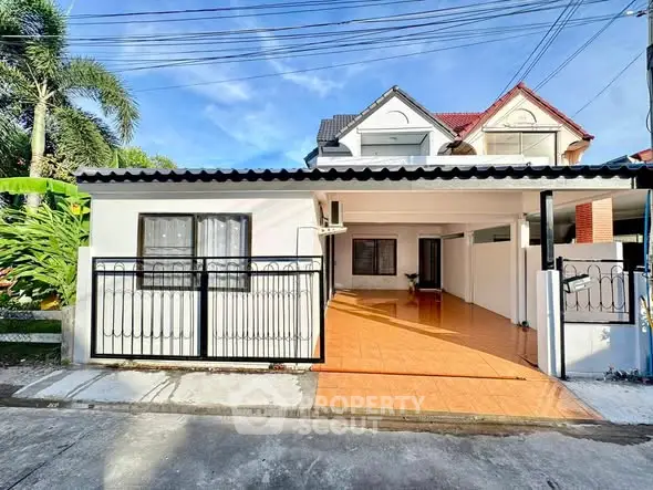 Charming suburban house with tiled driveway and modern facade.