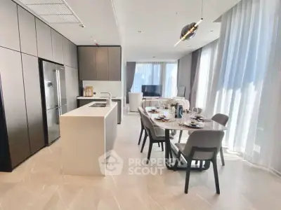 Luxurious open-plan kitchen and dining area with modern appliances and elegant decor.