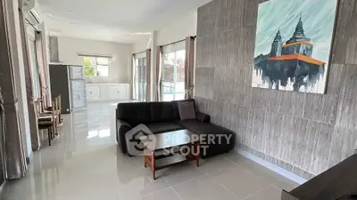 Spacious living room with modern decor and natural light in a stylish apartment.