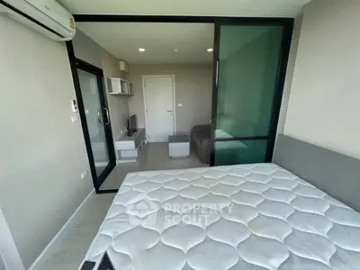Modern bedroom with glass partition and air conditioning in a stylish apartment.