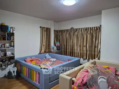 Cozy children's bedroom with colorful bed and ample natural light