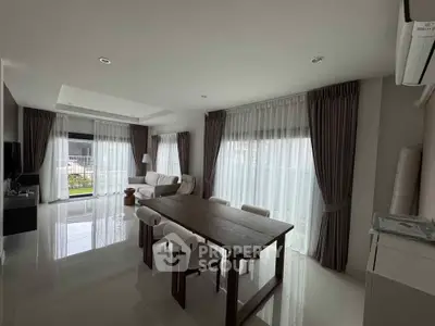 Spacious modern living room with elegant dining area and large windows