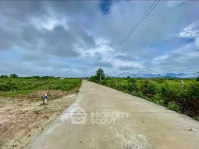 Expansive land plot with paved road access and scenic views, ideal for development opportunities.