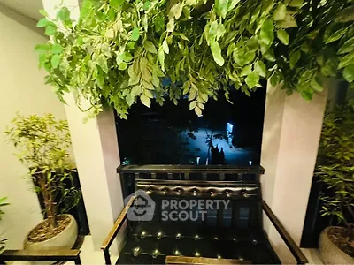 Charming balcony with lush greenery and cozy seating, perfect for relaxation.