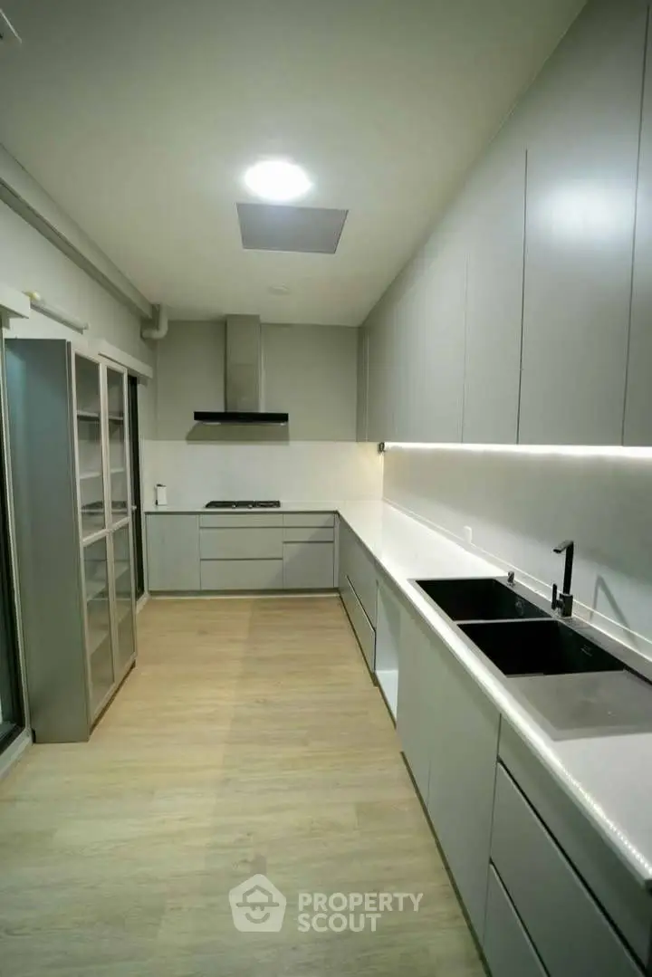 Modern kitchen with sleek cabinetry and spacious layout, featuring a gas stove and ample counter space.