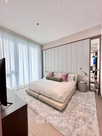Luxurious bedroom with modern decor and floor-to-ceiling windows in a high-end apartment.