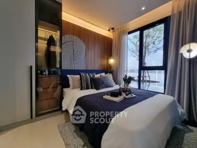 Luxurious bedroom with modern decor and stunning water view, featuring elegant lighting and stylish furnishings.
