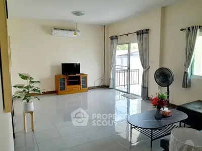 Spacious living room with balcony access and modern furnishings