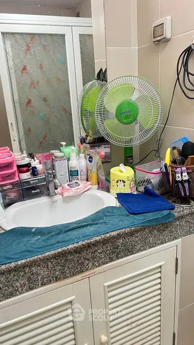 Compact bathroom with granite countertop and essential toiletries
