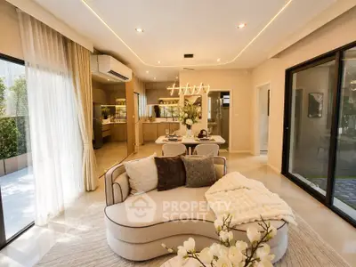 Luxurious open-plan living room with elegant decor and modern kitchen