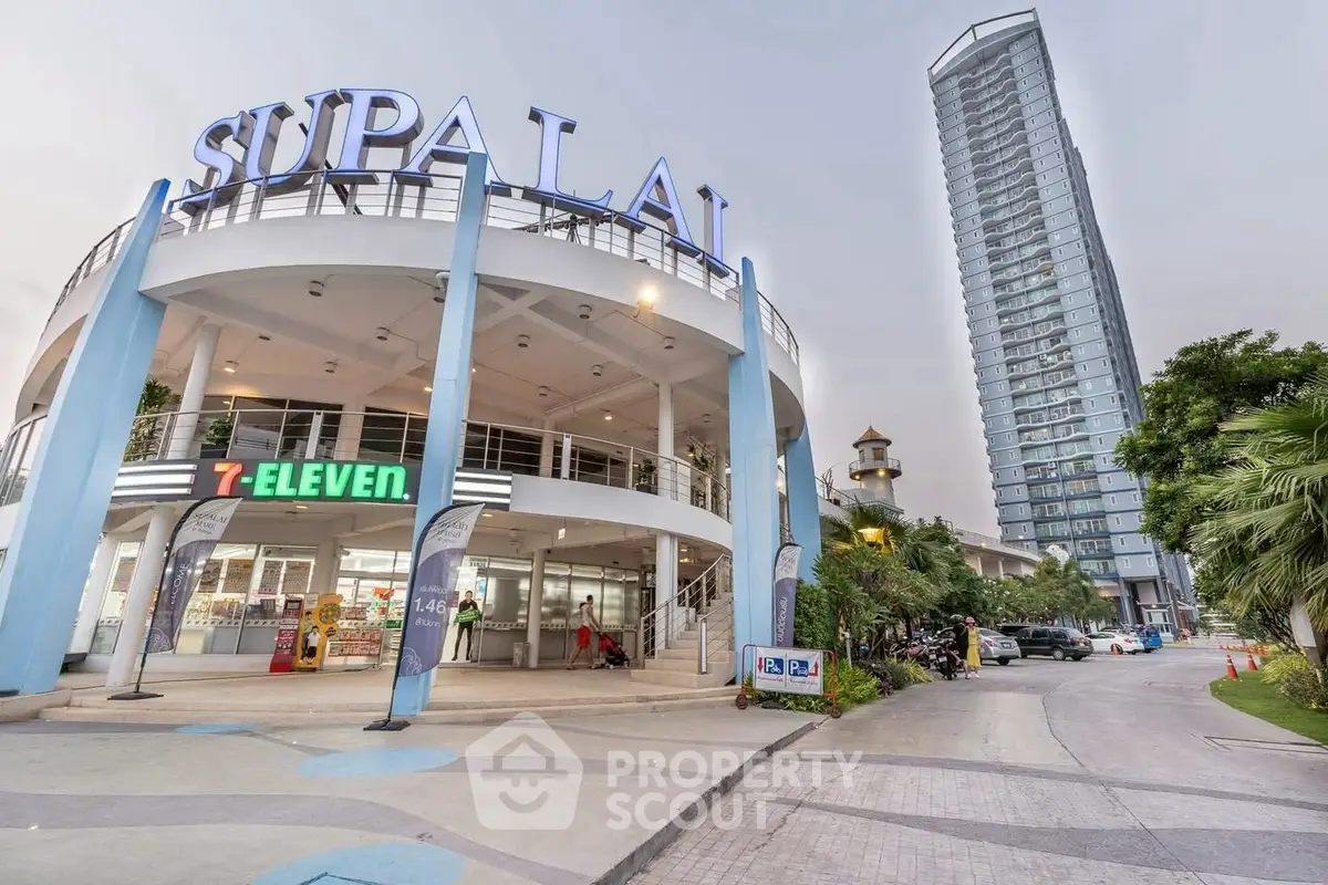 Modern commercial building with retail stores and high-rise residential tower