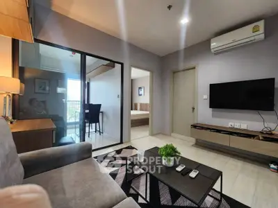 Modern living room with sleek furniture and balcony view