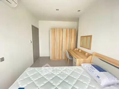 Modern minimalist bedroom with wooden furniture and natural light