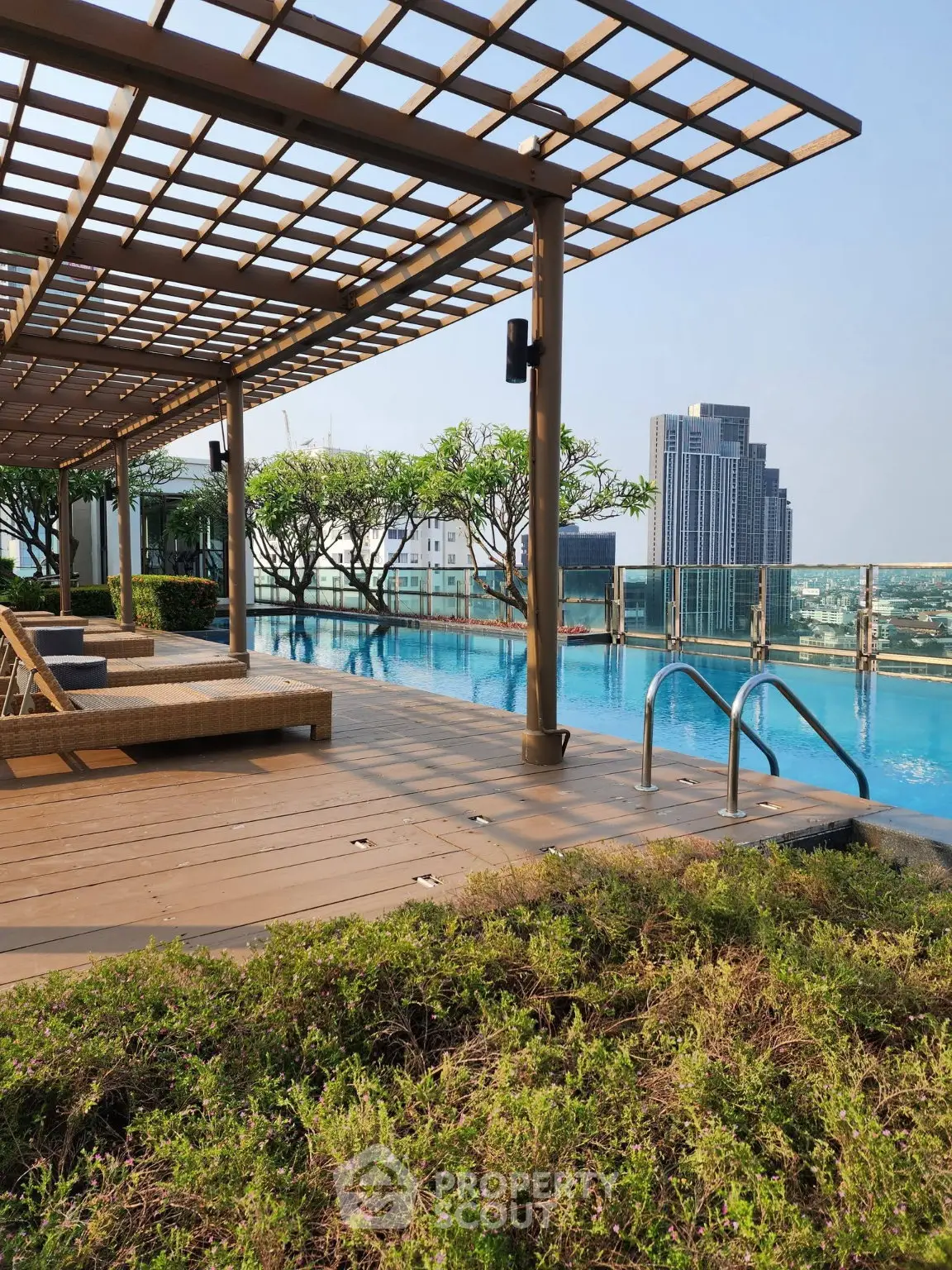 Luxurious rooftop pool with stunning city views and elegant lounging area.