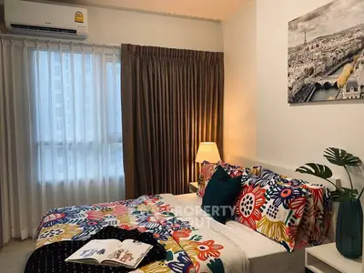 Cozy bedroom with vibrant floral bedding and cityscape artwork, perfect for urban living.