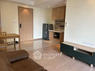 Modern living room with open kitchen and stylish furniture in a cozy apartment.