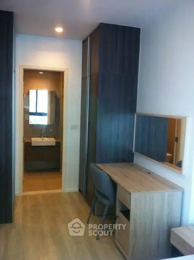 Modern apartment interior with study area and bathroom view