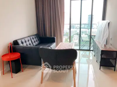 Modern living room with city view, featuring sleek furniture and large windows for natural light.