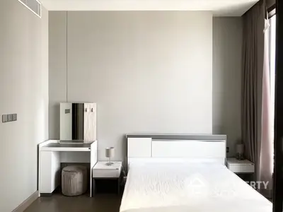 Sleek modern bedroom with a minimalist design, featuring a large comfortable bed, crisp white linens, and a compact workspace, perfect for relaxation and productivity.