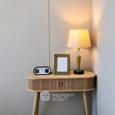 Stylish corner table with lamp and decor in modern living room