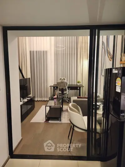 Modern living room with stylish furniture and open layout, featuring a sleek TV unit and elegant decor.