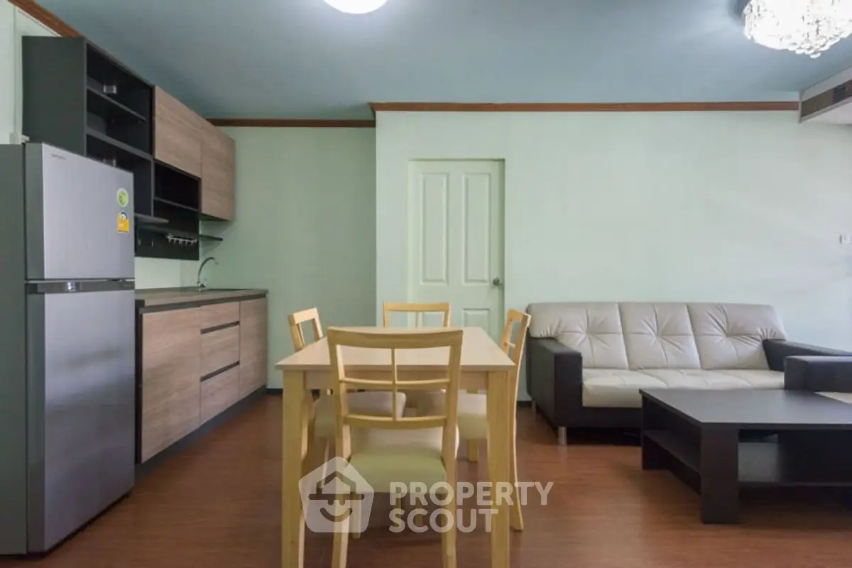 Modern living room with kitchen, dining table, and sofa in open layout