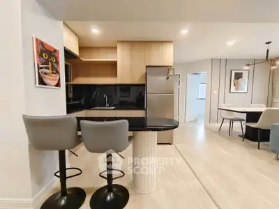 Modern kitchen with sleek design, featuring a breakfast bar and stylish decor, perfect for contemporary living.