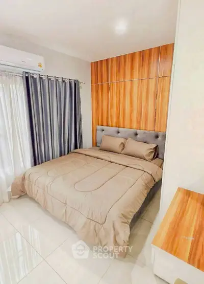 Modern bedroom with elegant wood paneling and cozy bedding