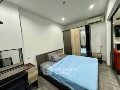 Modern bedroom with sleek furniture and air conditioning in a stylish apartment.