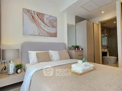 Modern bedroom with stylish decor and en-suite bathroom in luxury apartment.