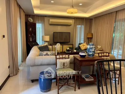 Elegant living room with stylish decor and natural light, featuring cozy seating and tasteful furnishings.