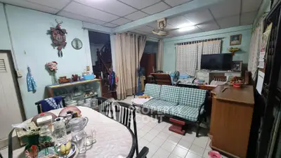 Charming living room with vintage decor and cozy seating area, perfect for family gatherings.